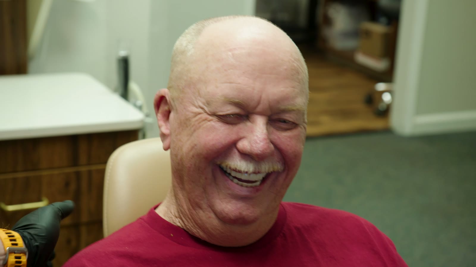 A patient laughing after treatment with Dr. Rauch